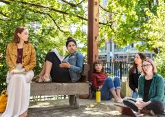Class seated outside in conversation