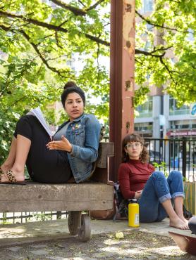 Class seated outside in conversation