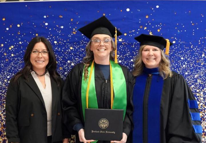 Michelle Ehlers in cap and gown at graduation ceremony, flanked by Suvanvej and Deb ArthurNahlee 