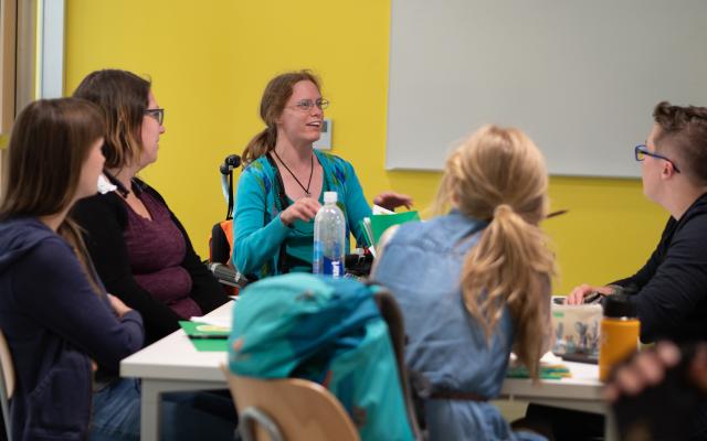 Students conversing around a table