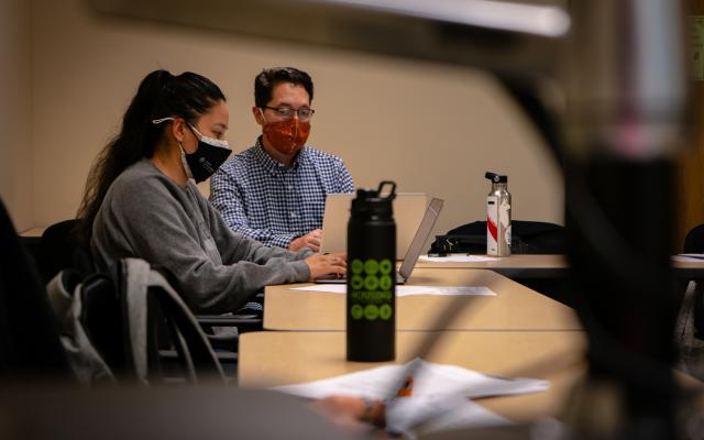 Two students on laptops