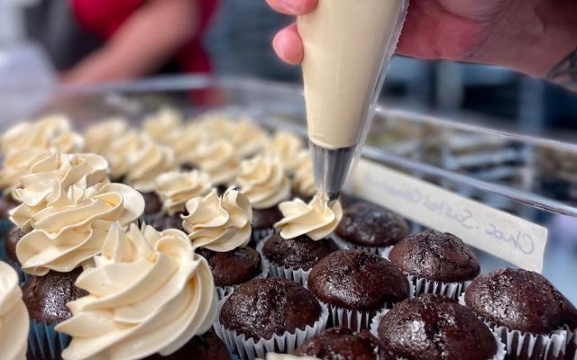 Person frosting cupcakes