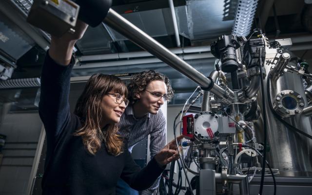 Students operating a large microscope