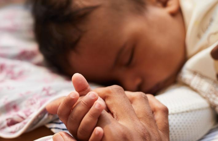 Baby holding mom's hand
