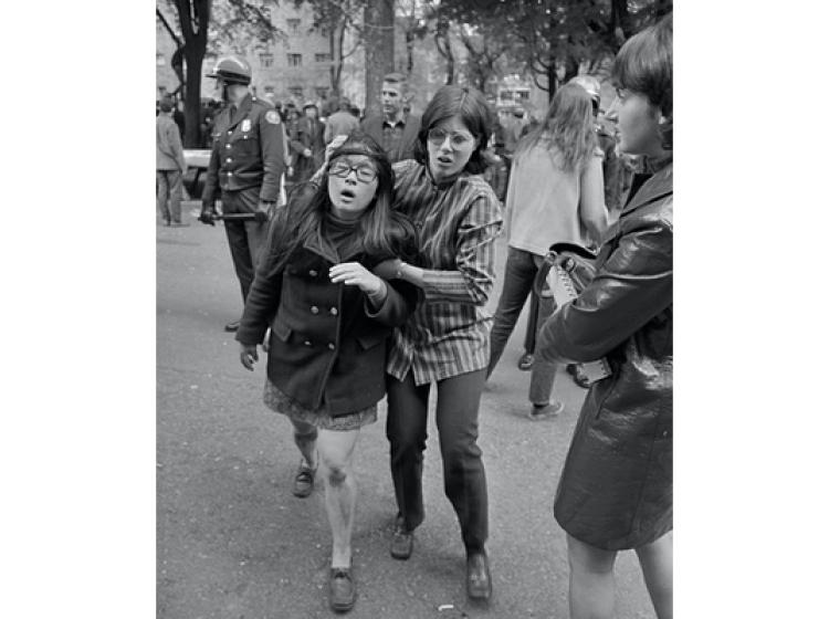 A student holds a cloth to another's bleeding head.