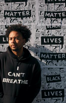 Joseph Blake Jr. with Black Lives Matter posters behind him