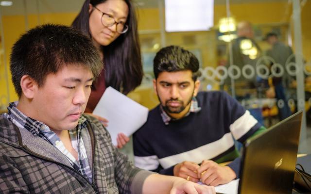 three students at a computer