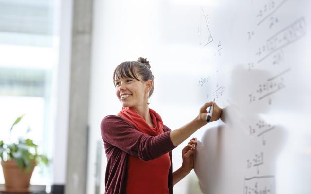 PSU graduate student teaching math to middle school students