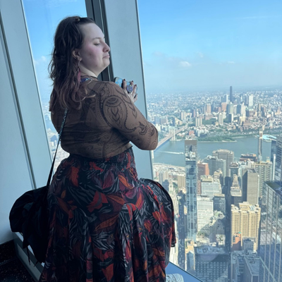 Singer looks out window at One World Observatory