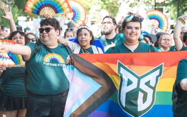 PSU students marching during pride with a pride flag