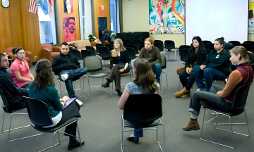 Students in a large discussion group circle