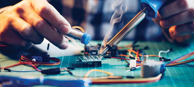 person soldering circuit board