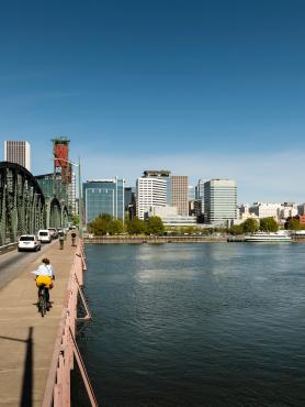 Biker on bridge toward Portland