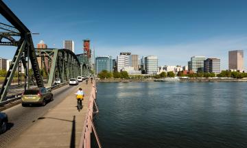 Biker on bridge toward Portland