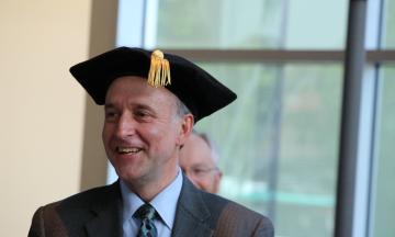 Dr. Gerry Recktenwald smiling while wearing graduation cap