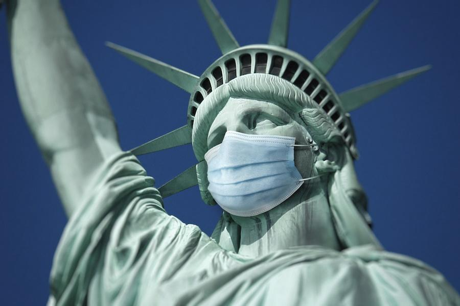 Image of the Statue of Liberty's head wearing a medical mask
