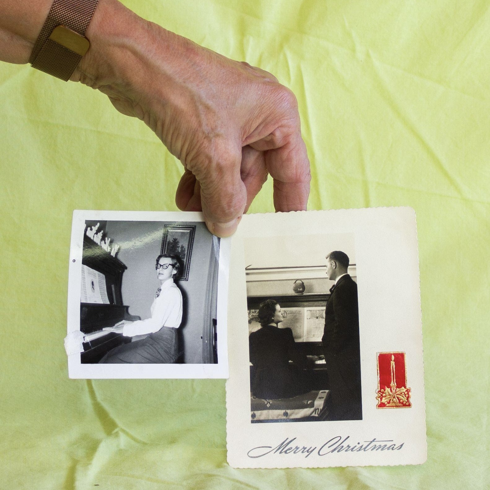 Hand holding two vintage images against a lime green backdrop