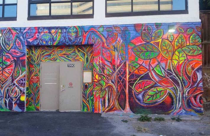 A brightly colored abstract mural on an exterior building wall.