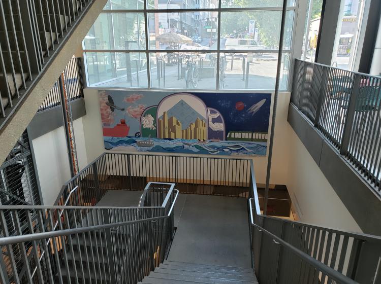 View of the mural from farther away, with the stairwell also visible.