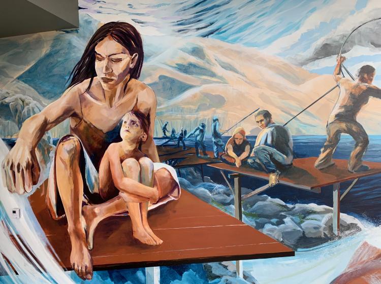 Close-up of a section of the mural that depicts a woman with child sitting on a wooden dock, with people in the background fishing for salmon.