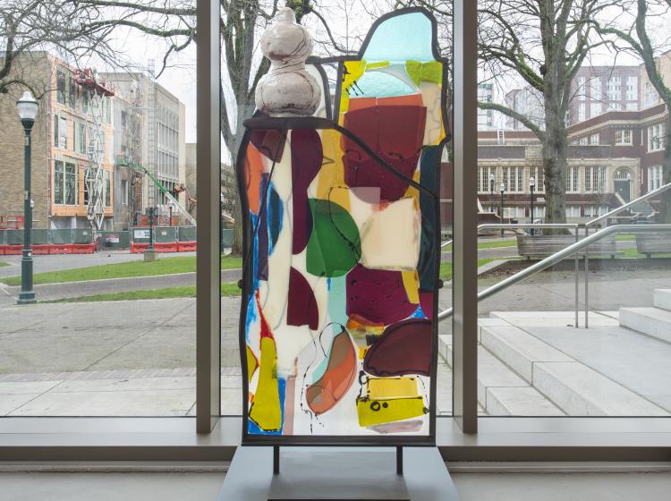 Straight-ahead view of the sculpture, in front of the Peter Stott Center atrium’s floor-to-ceiling windows.