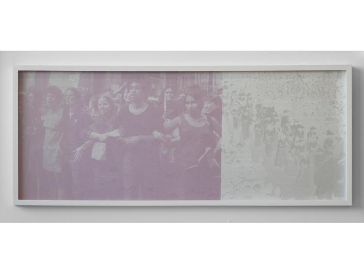 The photo is shown as it appears in normal light. Its colors are primarily white and pink, and figures can be seen, but the imagery is hard to make out.