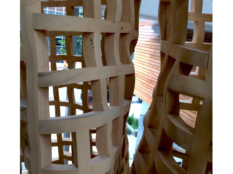 Close-up of part of the sculpture, showing an area where two trunk-like structures can be seen running vertically parallel to each other.