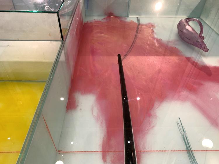 Detail shot of a section of the artwork, featuring a red painted area enclosed by geometric glass compartments