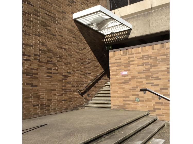 The secondary section of the artwork is seen, a smaller canopy over the northeast entrance to the building