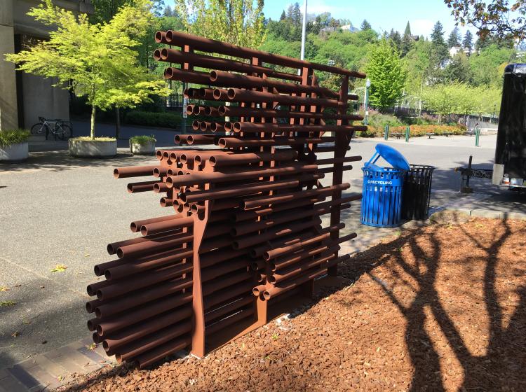 The sculpture is seen from an angle, so that it's harder to make out the image of the cyclist.