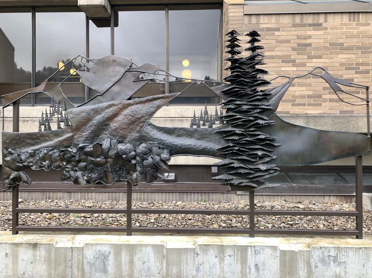 A section of the sculpture, depicting trees and mountains