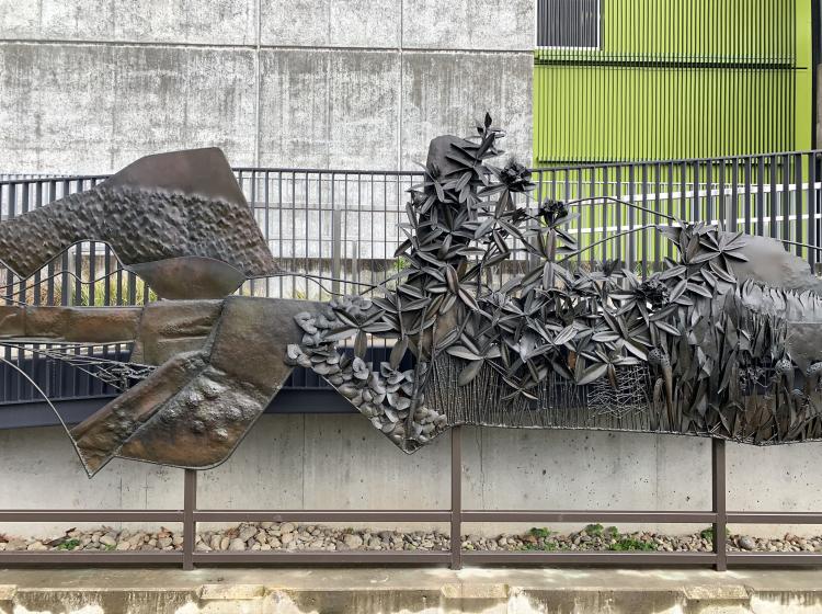 A section of the sculpture, depicting hills and leafy vegetation