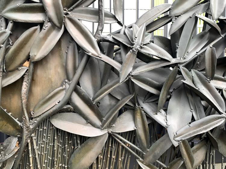 Close-up of a section of the sculpture, depicting leafy vegetation