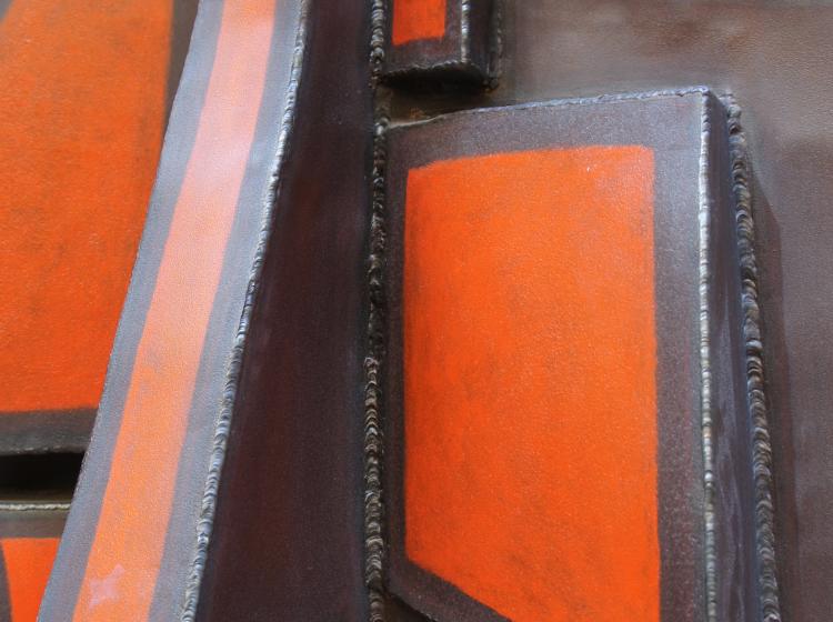 Close-up of the sculpture's surface. Welding is visible in the joints between different components