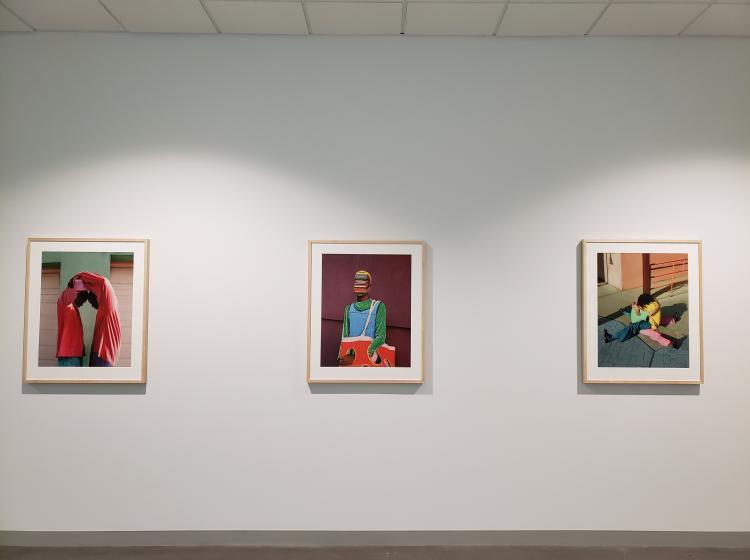 All three framed photos are seen hung side-by-side on a white wall