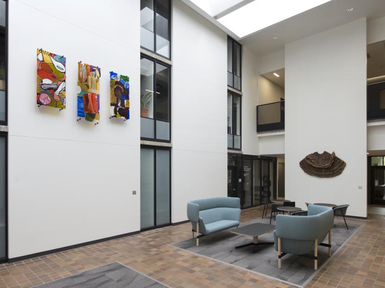 A wide shot of the study lounge in Fariborz Maseeh Hall, with the glass artworks visible high on the wall at left