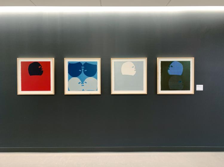 All four prints are shown individually framed, side by side on a dark grey wall