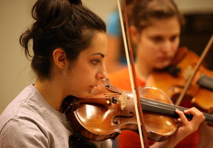 Violin students in rehearsal