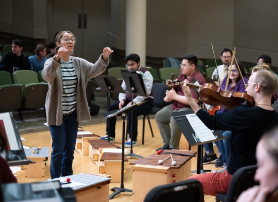 Photo of a PSU music education student conducting