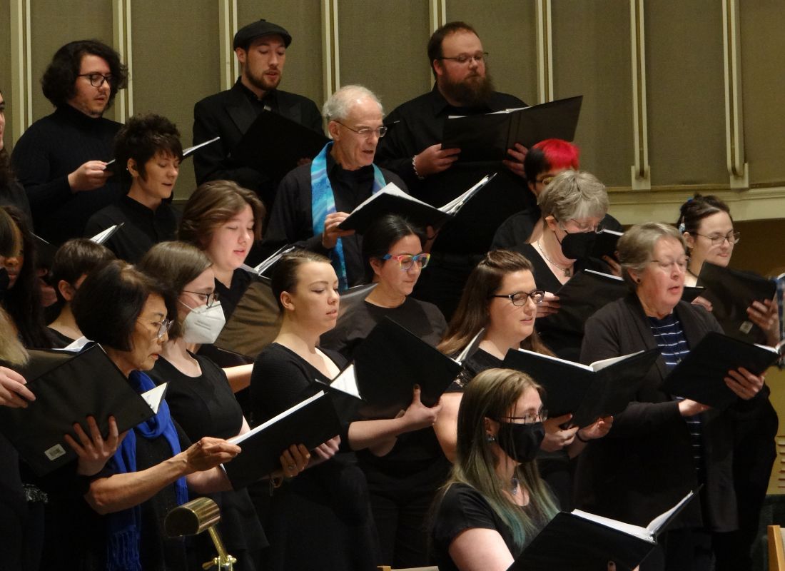 Photo of the PSU University Choir singing with music folders.