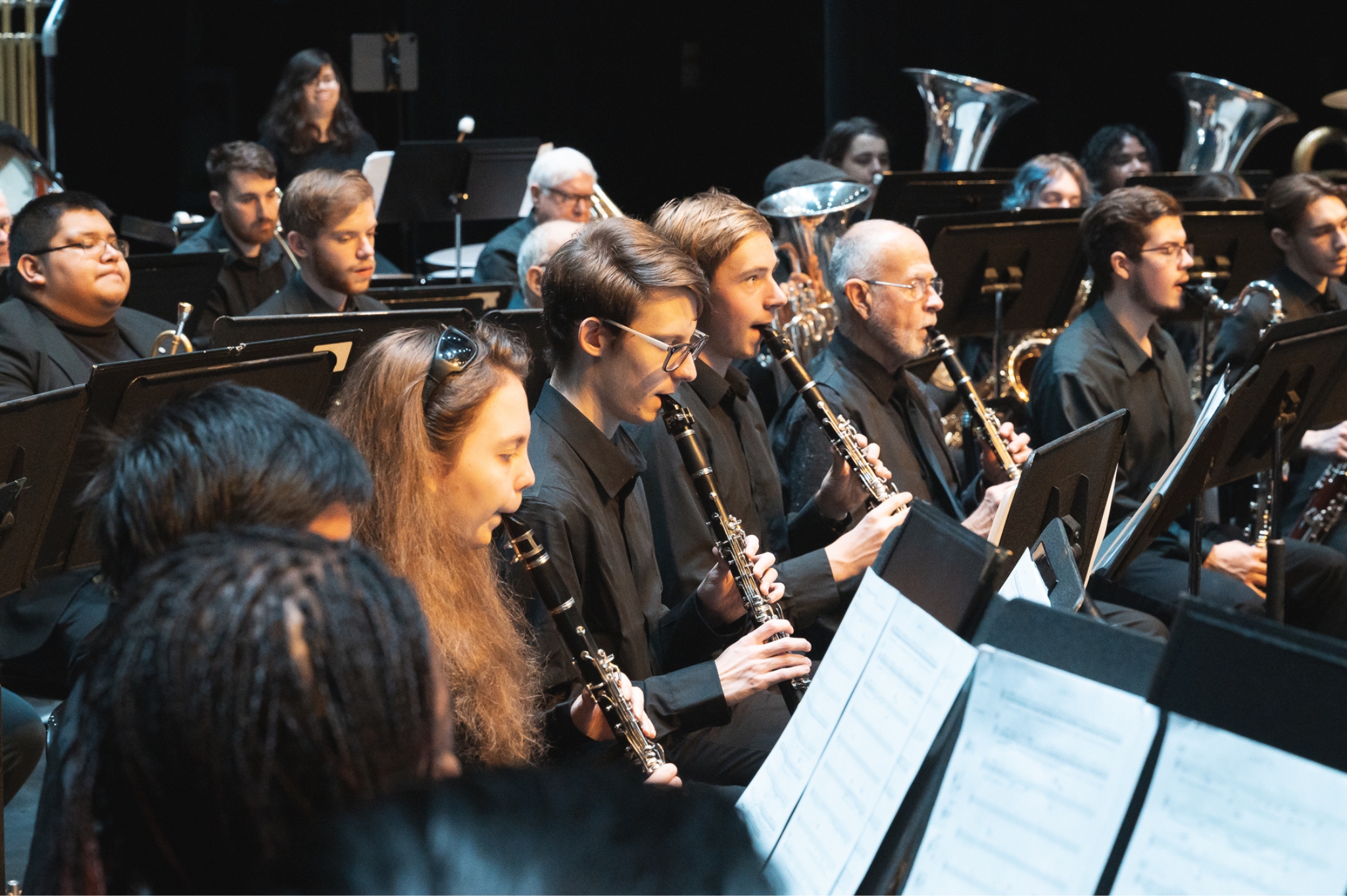 Members of the PSU Wind Symphony playing clarinets in a concert.