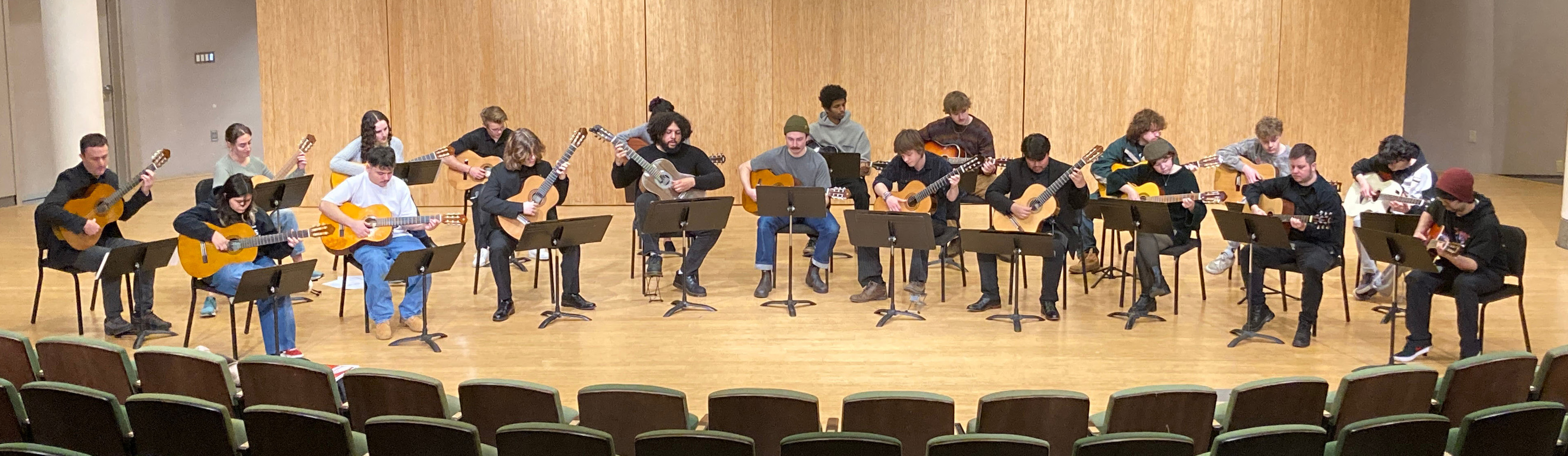 A large group of guitar students performing in Lincoln Recital Hall.