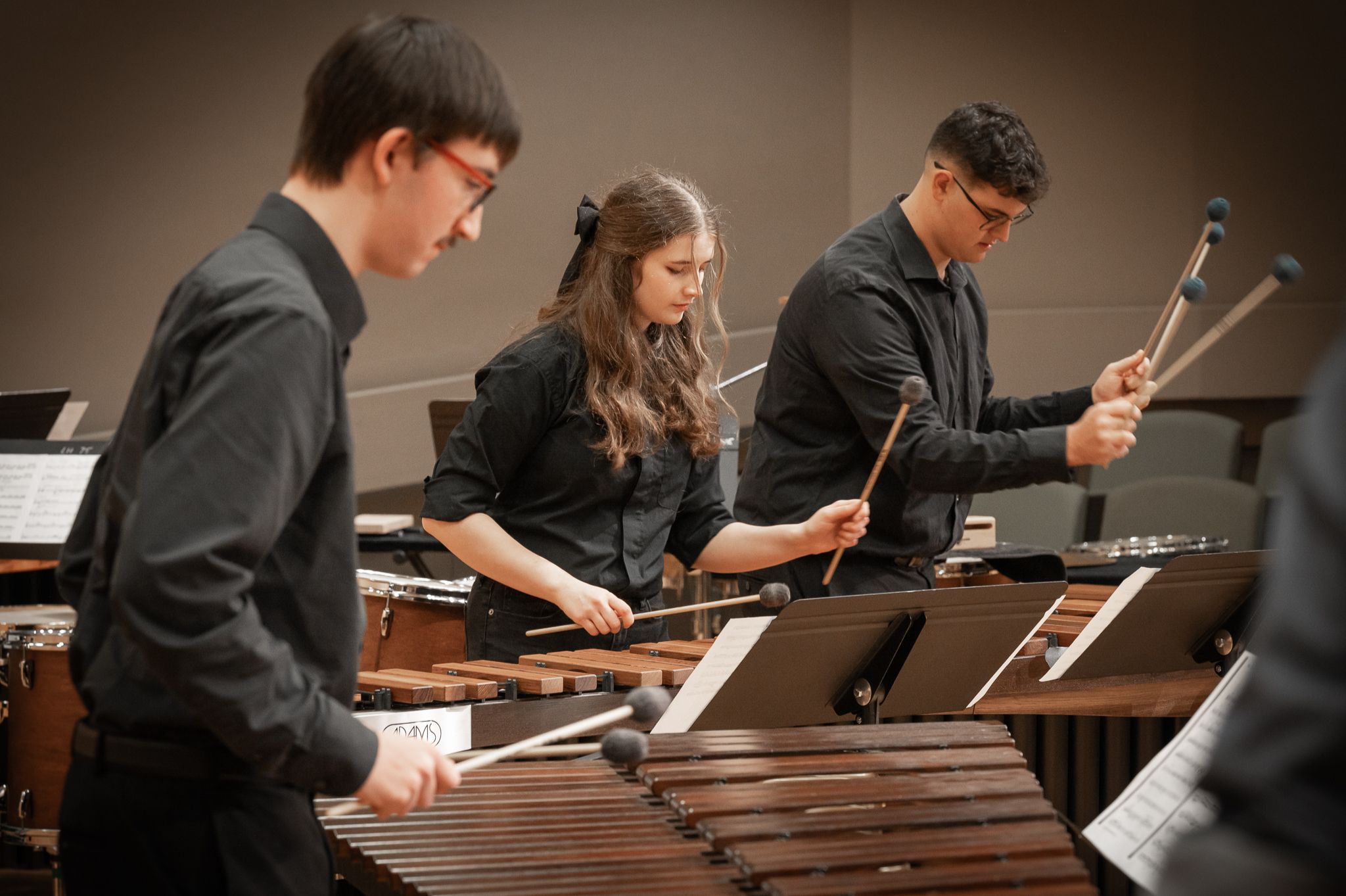 Three students playing marimbas.