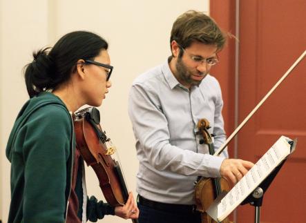 Violin student and instructor in private lesson