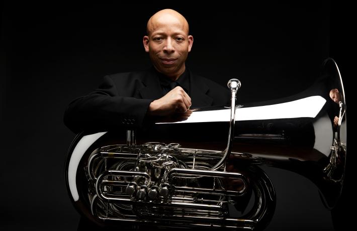 Headshot of JaTtik Clark with a tuba