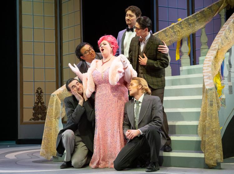 Hanna surrounded by suitors in PSU Opera's "The Merry Widow"