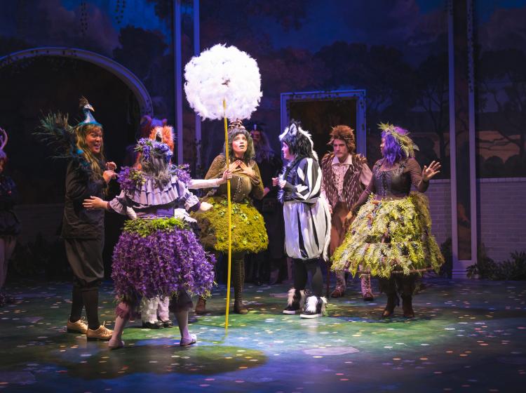 PSU Opera students performing, dressed as fairies and half blood forest beings, and holding a larger than life dandelion puff.