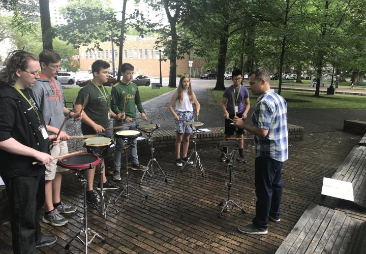 PSPA Students rehearsing stick technique in the park blocks