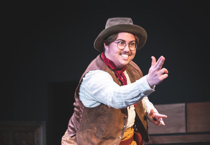 Actor in costume pretending to shoot a gun