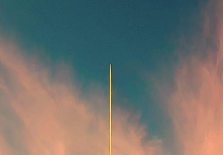 rocket ship rising into the sky.